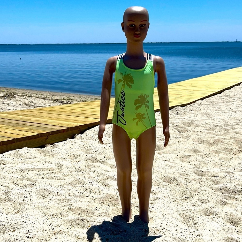 LITTLE girl’s one piece Justice bathing suit in this year’s popular color